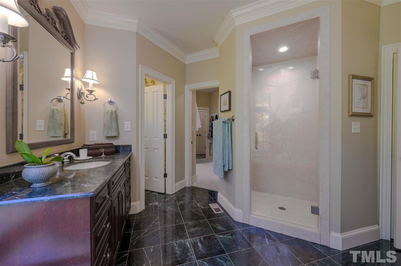 317 Homestead Drive Cary, NC 27513 - Photo 14 of 30 a bathroom with a granite countertop sink a toilet and shower