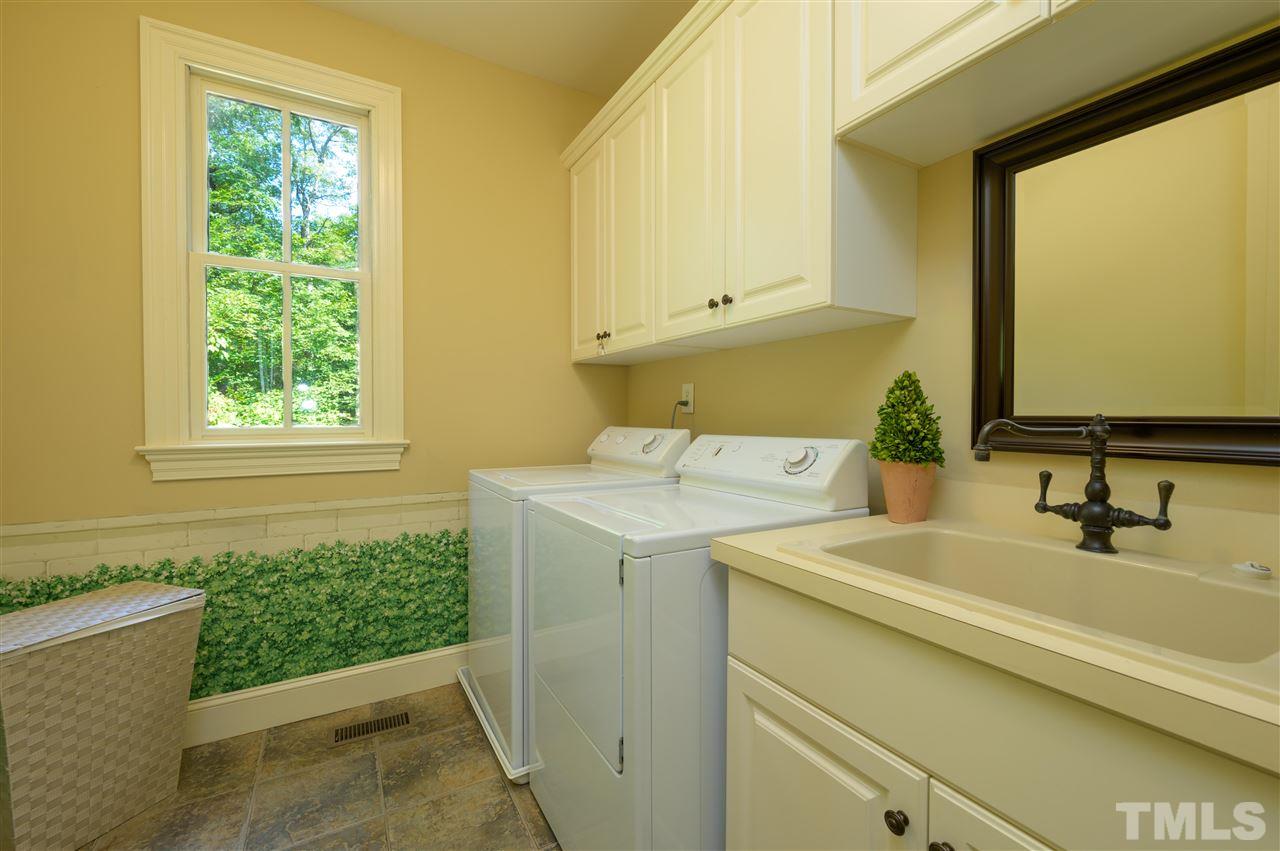 317 Homestead Drive Cary, NC 27513 - Photo 15 of 30 a bathroom with a sink and a mirror