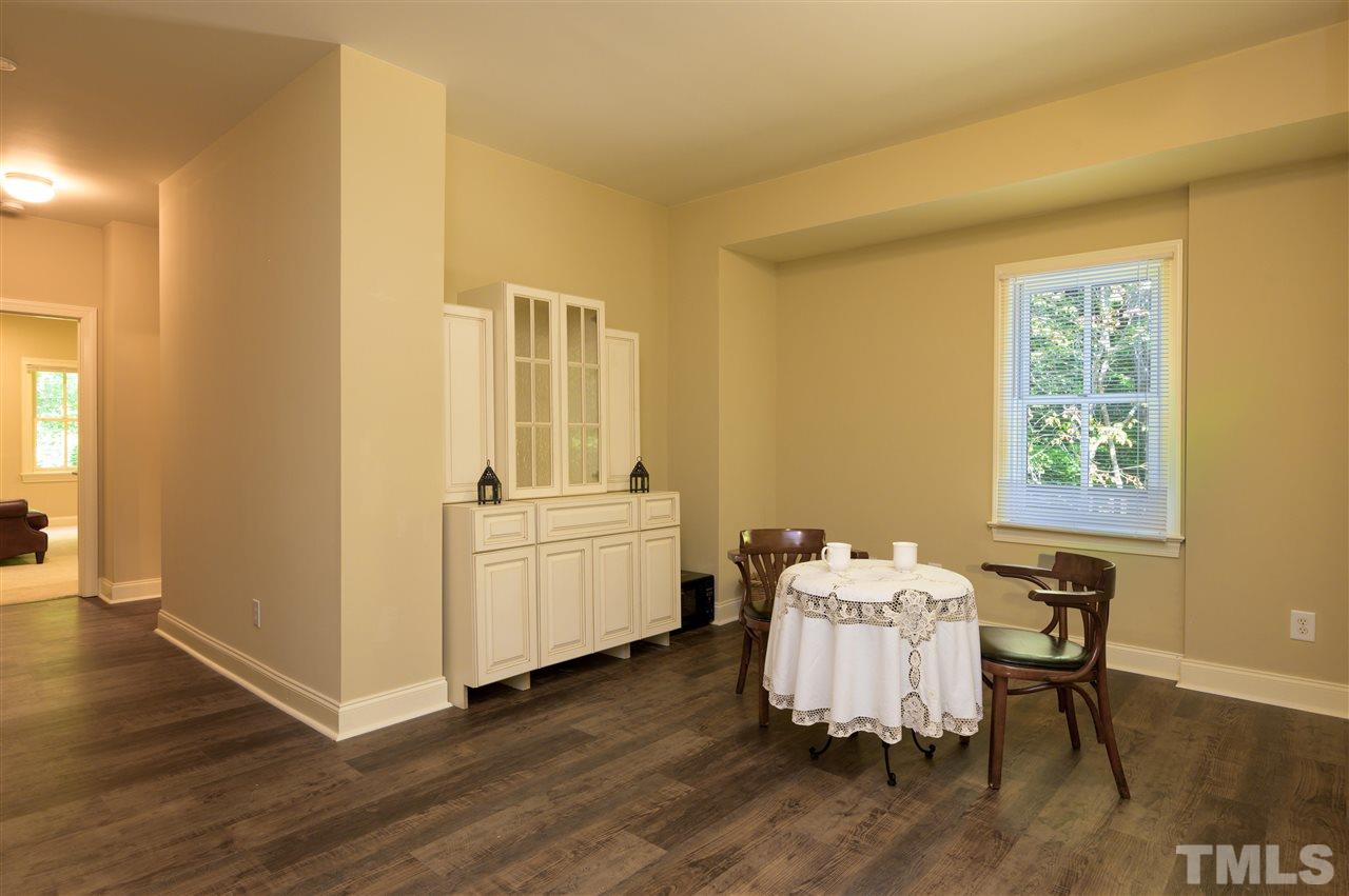317 Homestead Drive Cary, NC 27513 - Photo 18 of 30 a room with furniture and wooden floor
