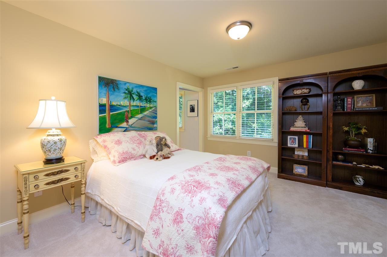 317 Homestead Drive Cary, NC 27513 - Photo 24 of 30 a bedroom with a bed and a book shelf