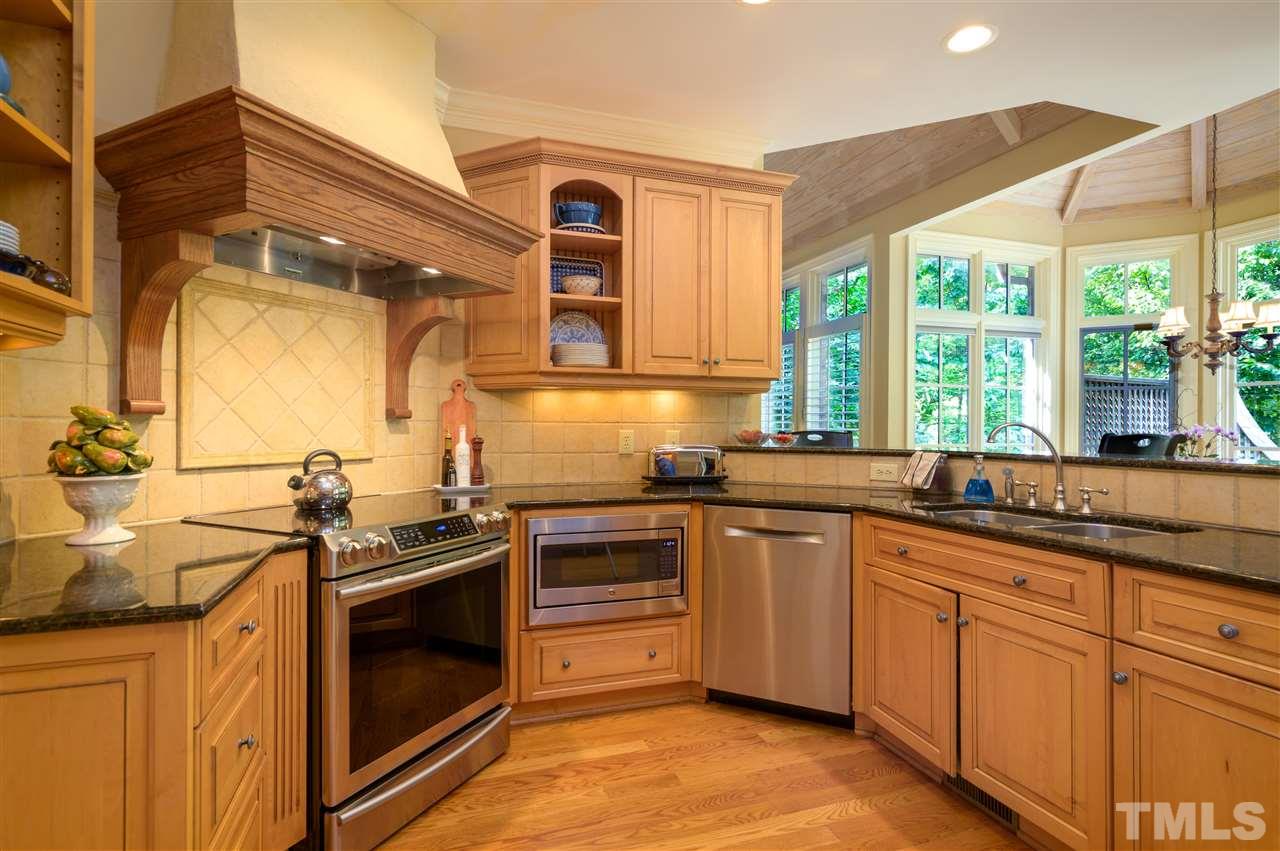 317 Homestead Drive Cary, NC 27513 - Photo 6 of 30 a kitchen with stainless steel appliances granite countertop a sink and a stove