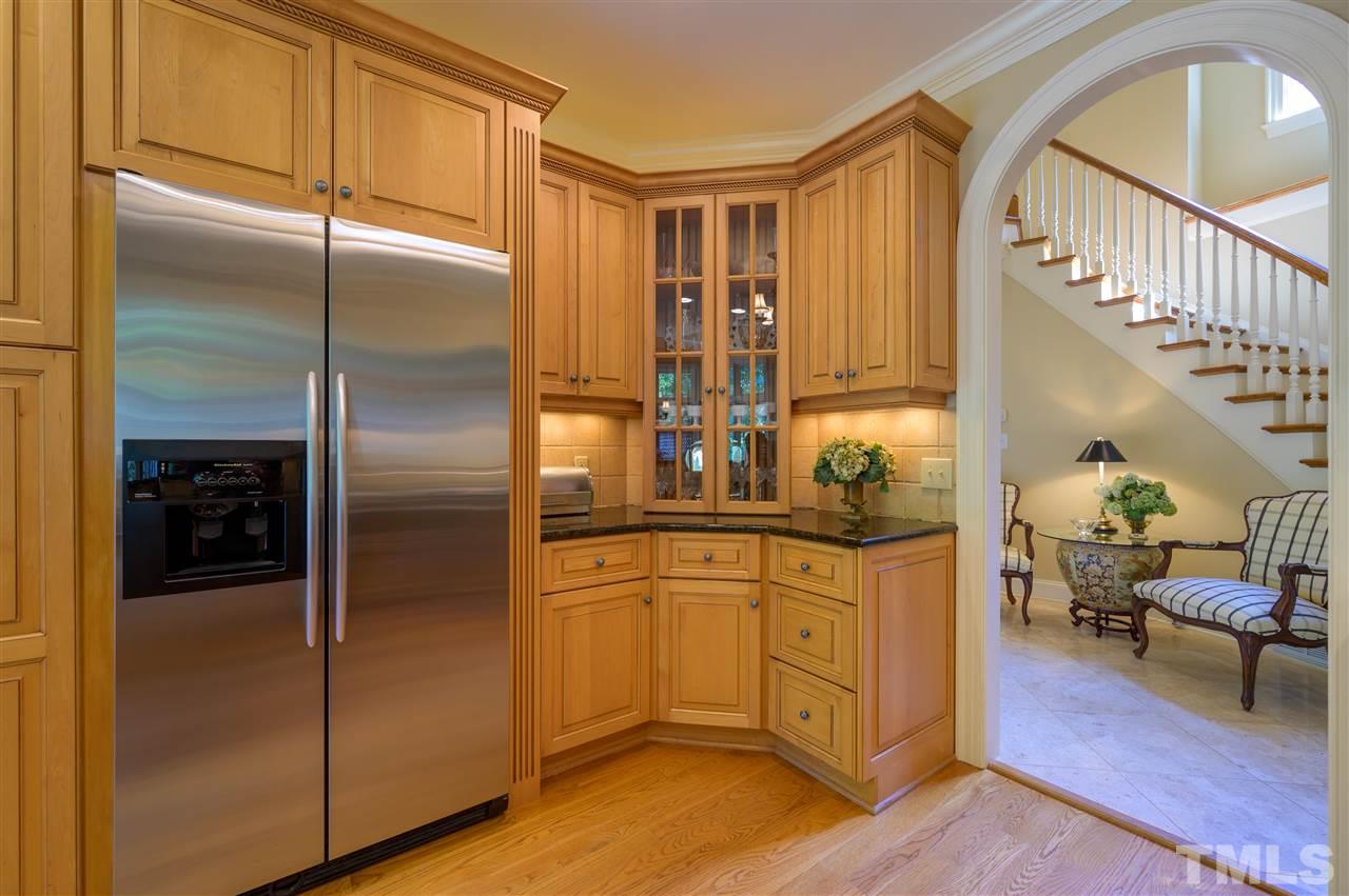 317 Homestead Drive Cary, NC 27513 - Photo 8 of 30 a kitchen with granite countertop a refrigerator and a sink