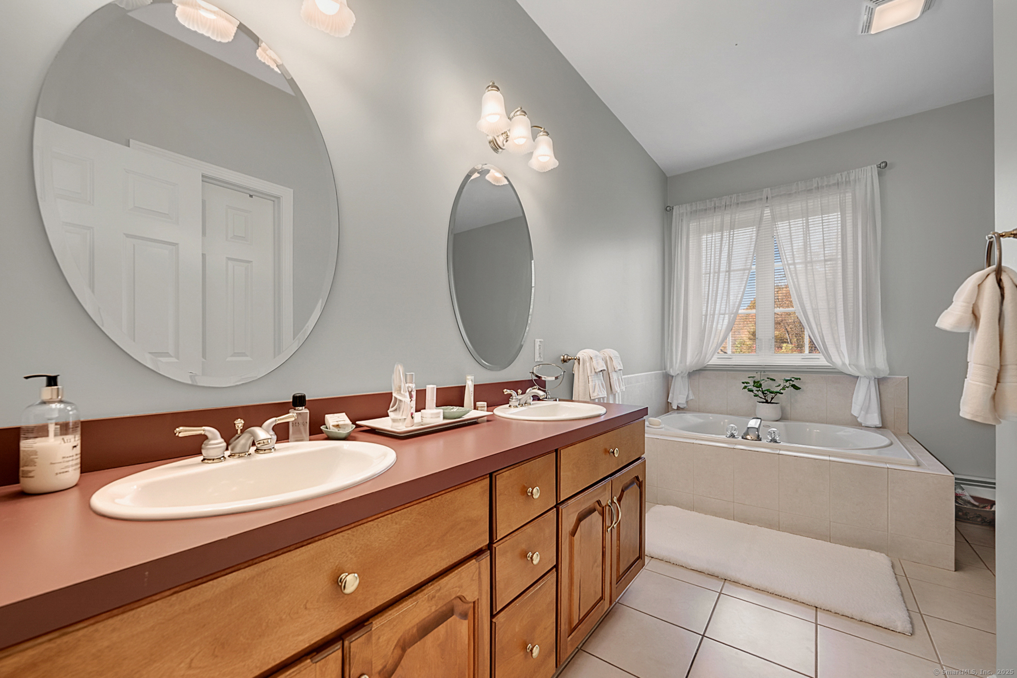 20 Cowles Road Bethlehem, CT 06751 - Photo 22 of 36 a bathroom with a double vanity sink and a mirror