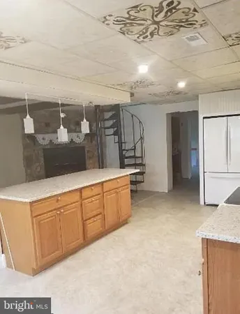 a spacious bathroom with a granite countertop sink and a mirror