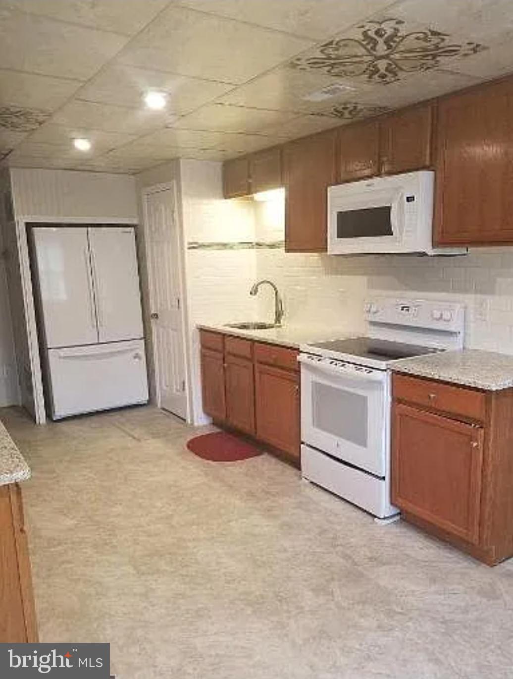 230 East High Street Glassboro, NJ 08028 - Photo 4 of 11 a kitchen with granite countertop a sink and white cabinets