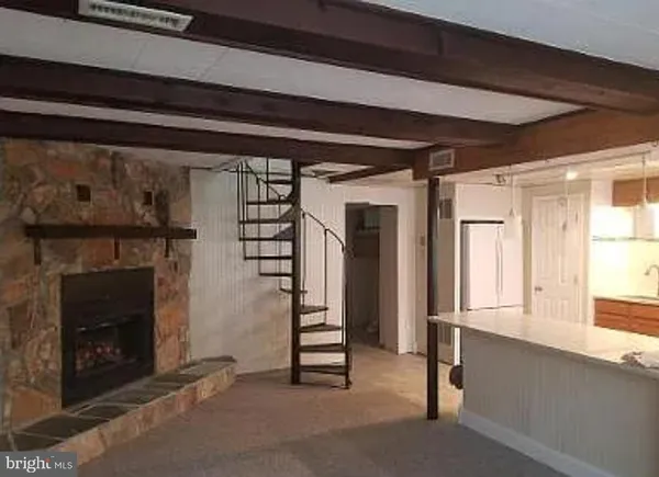 a view of an empty room with a fireplace