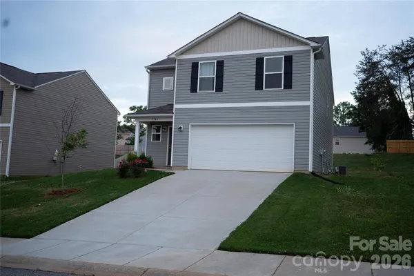 a front view of a house with a garden and yard