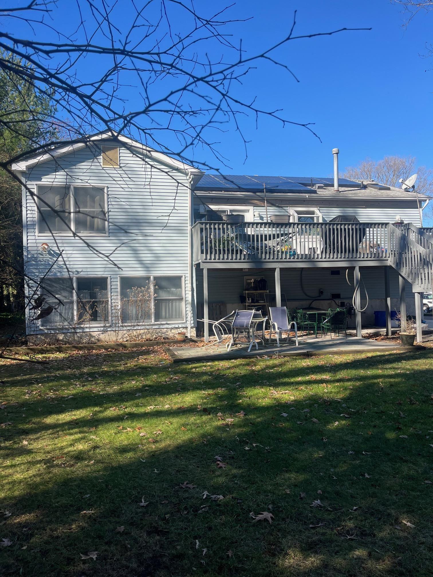 6 Abbey Road Somers Point, NJ 08244 - Photo 5 of 6 a view of a house with a swimming pool and a yard