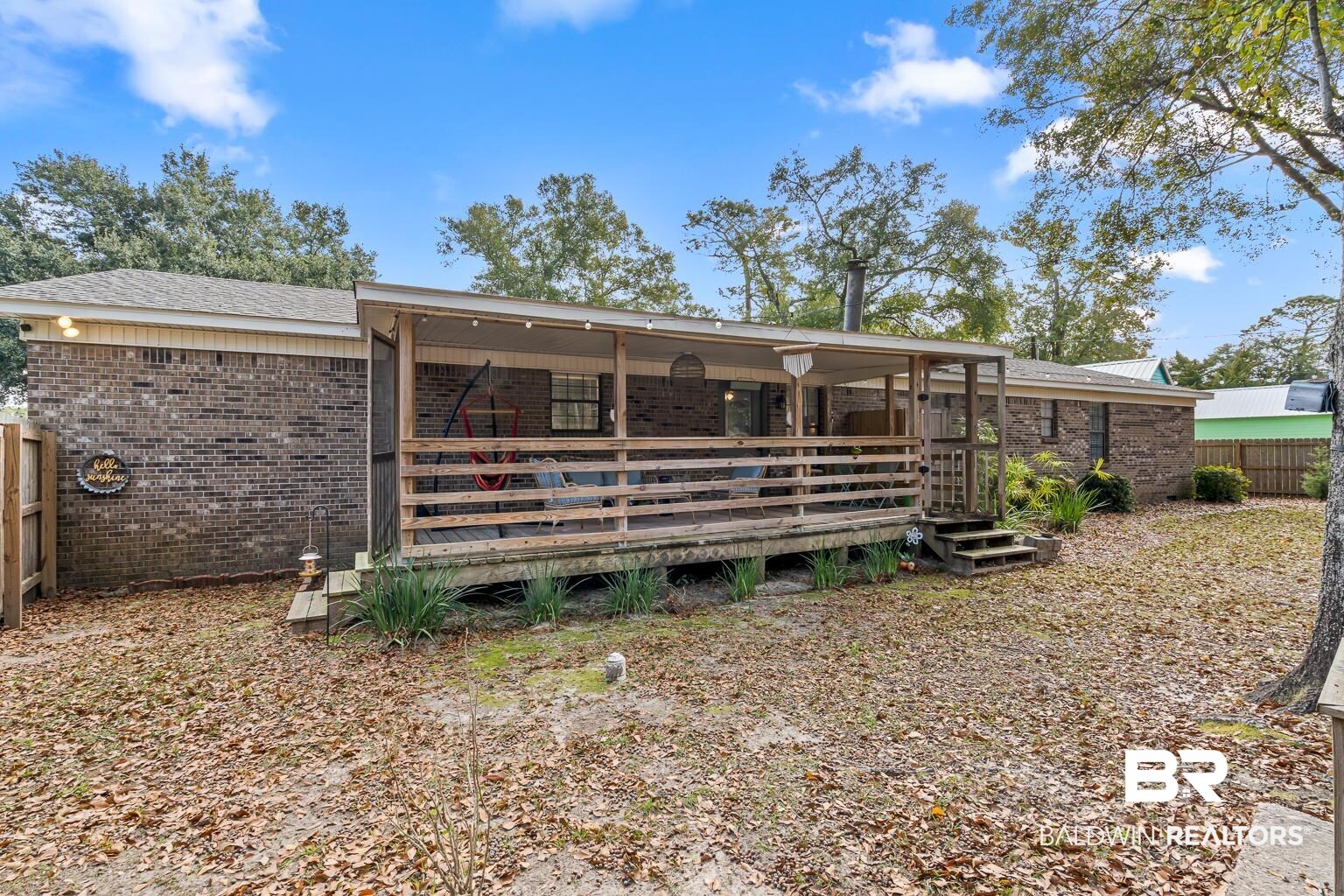 6801 Piney Woods Road Foley, AL 36535 - Photo 65 of 74 Rear view of property with a wooden deck and brick siding
