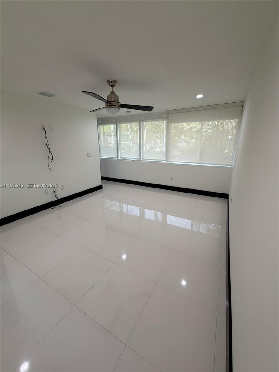 2699 Tigertail Avenue, Unit 14 Miami, FL 33133 - Photo 12 of 28 wooden floor in an empty room with a window