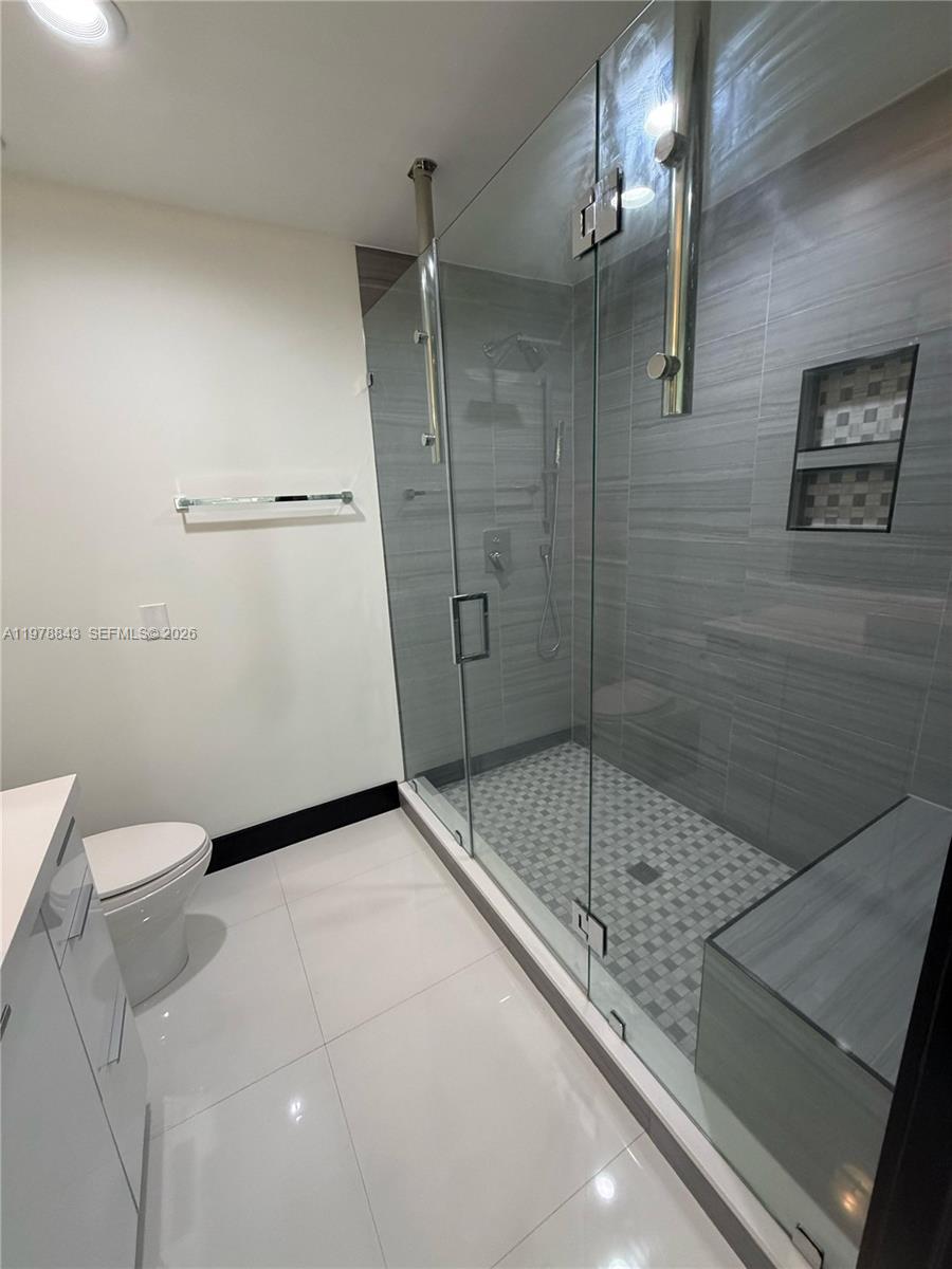 2699 Tigertail Avenue, Unit 14 Miami, FL 33133 - Photo 14 of 28 a bathroom with a shower and toilet