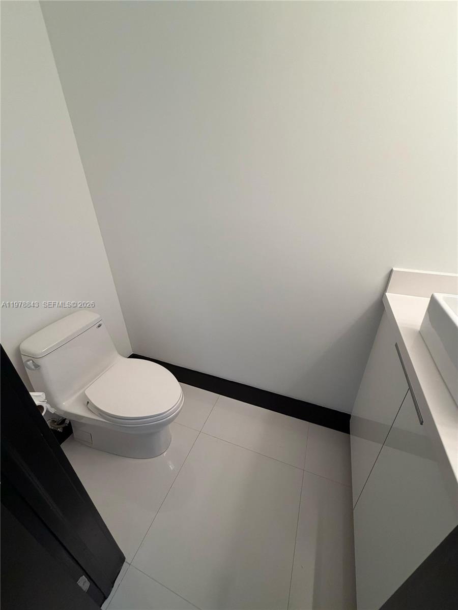 2699 Tigertail Avenue, Unit 14 Miami, FL 33133 - Photo 18 of 28 a white toilet sitting next to a shower