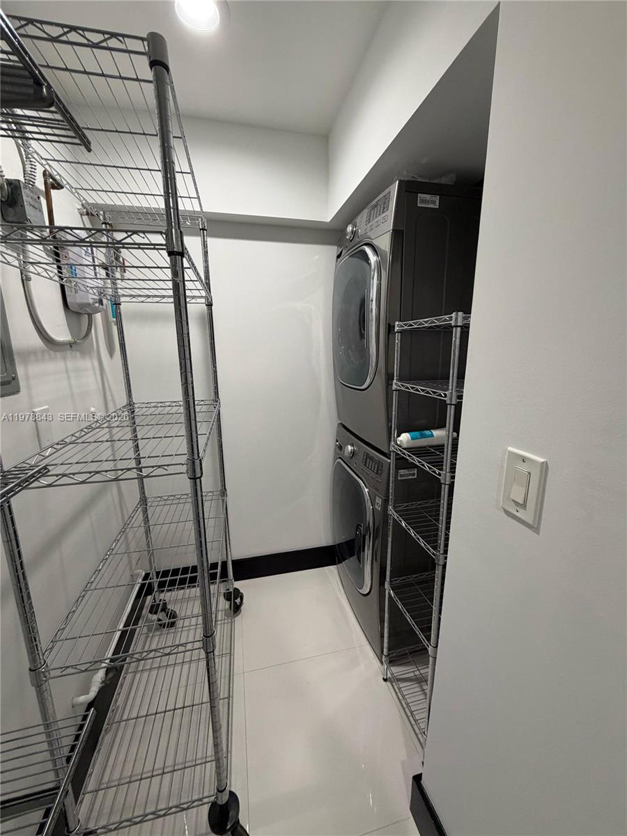 2699 Tigertail Avenue, Unit 14 Miami, FL 33133 - Photo 19 of 28 a view of walk in closet with clothes and shoes