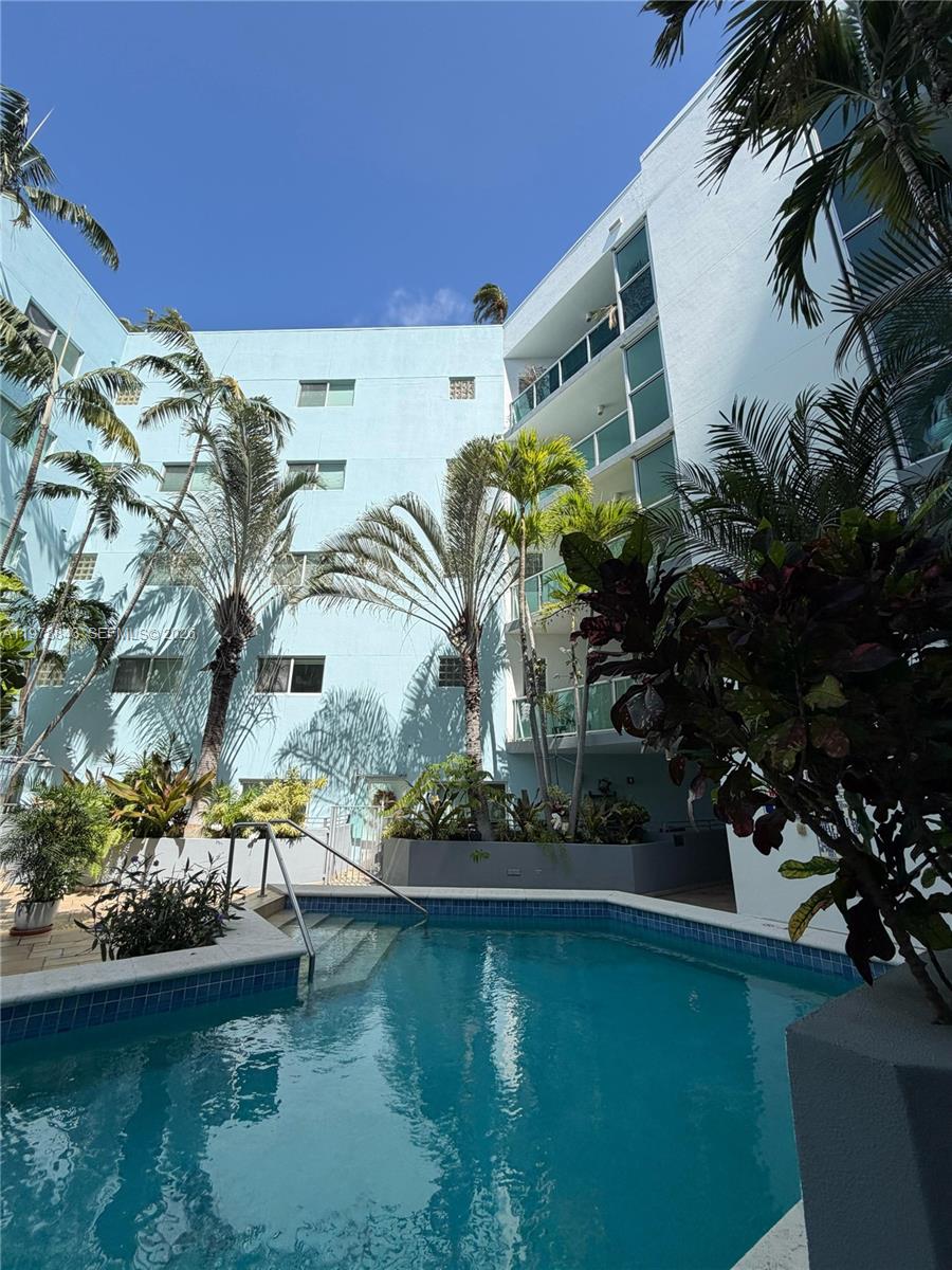 2699 Tigertail Avenue, Unit 14 Miami, FL 33133 - Photo 23 of 28 a view of a swimming pool with a yard