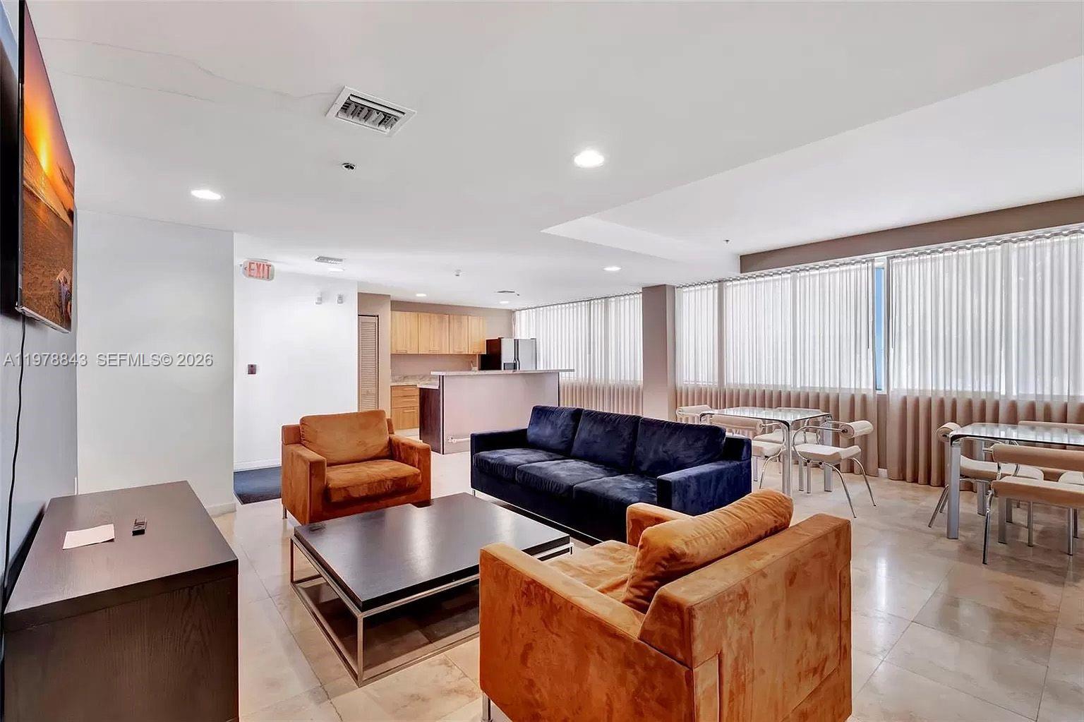 2699 Tigertail Avenue, Unit 14 Miami, FL 33133 - Photo 27 of 28 a living room with furniture and a flat screen tv