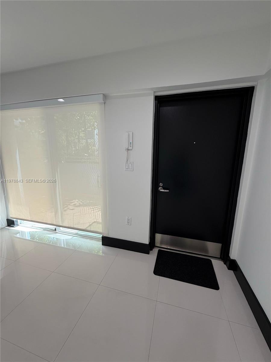 2699 Tigertail Avenue, Unit 14 Miami, FL 33133 - Photo 6 of 28 wooden floor in an empty room
