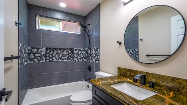 a bathroom with a sink toilet and shower
