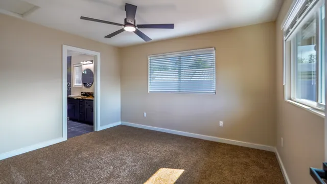 an empty room with windows and closet