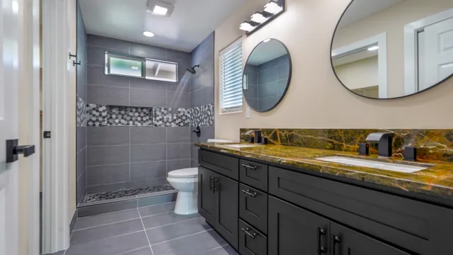 a bathroom with a granite countertop double vanity sinks and a mirror