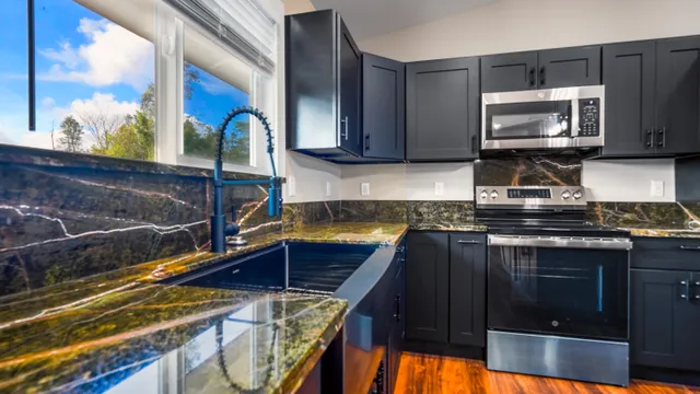 a kitchen with a sink cabinets and stainless steel appliances