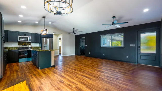 a view of kitchen with sink and refrigerator