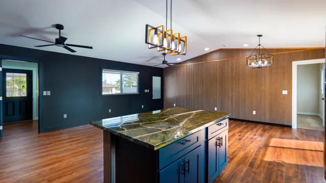 a kitchen with a wooden floor and chandelier