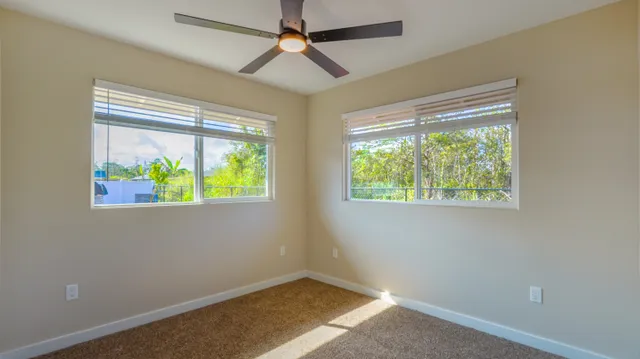 a view of room with window and ceiling fan