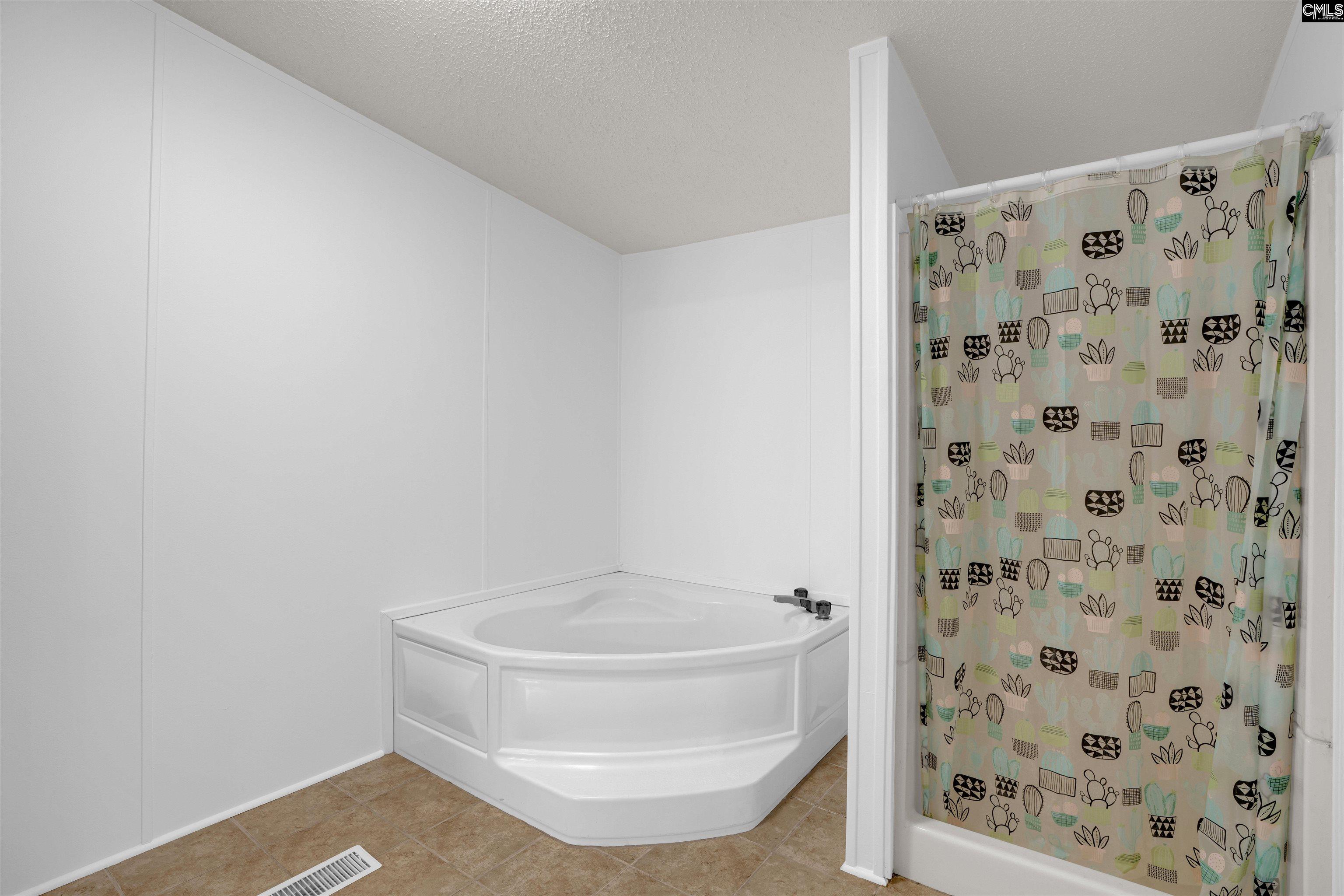 304 Cooper Road Blythewood, SC 29016 - Photo 17 of 29 a bathroom with a shower and a toilet