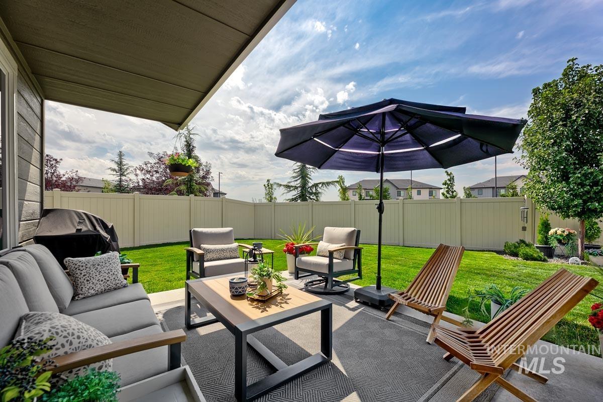 348 West Radiant Rdg Drive Meridian, ID 83642 - Photo 25 of 36 Spacious concrete patio with an overhead awning, fenced backyard, and established landscaping