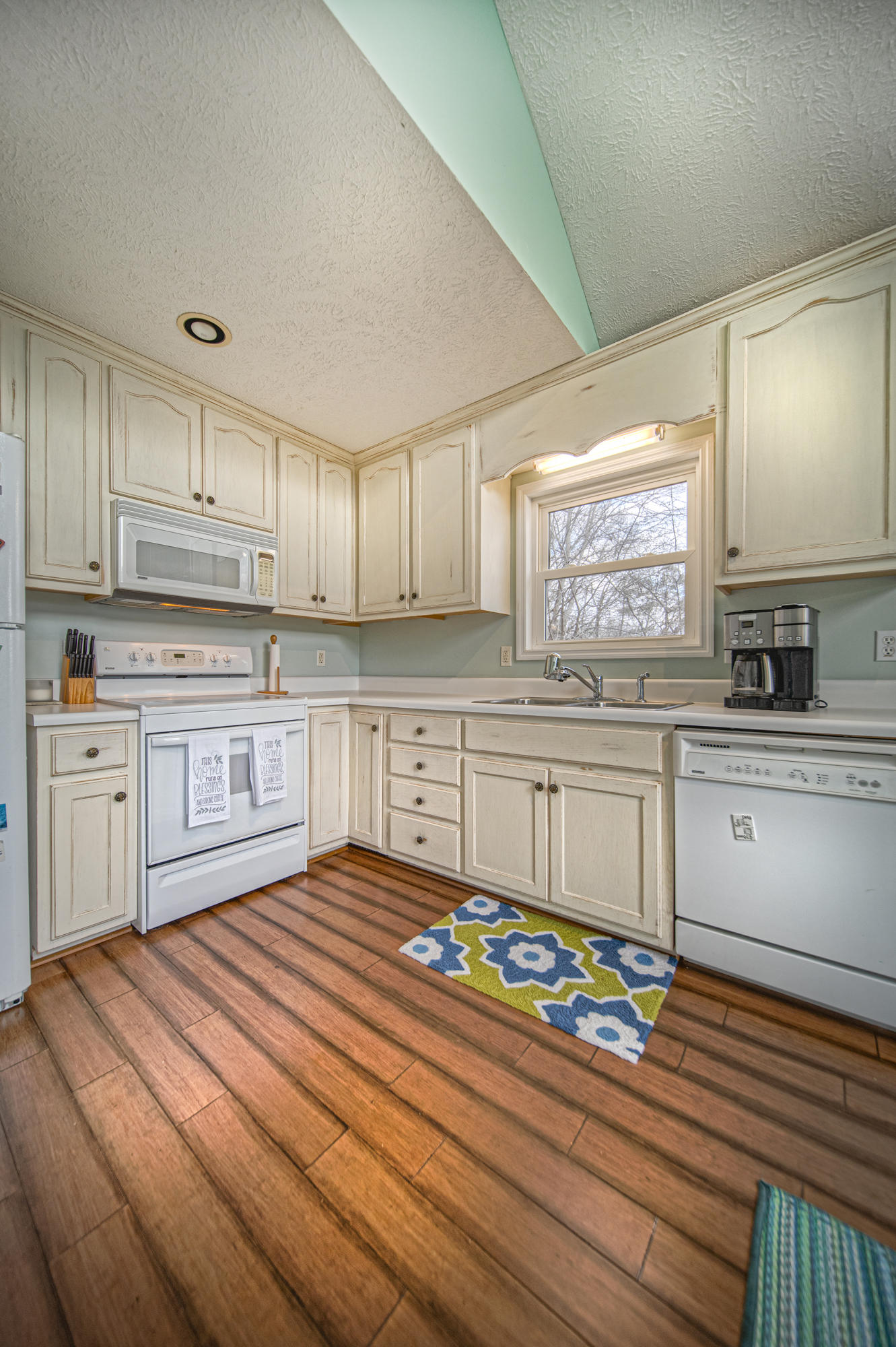 6136 Horseshoe Bend Road Goodview, VA 24095 - Photo 12 of 35 a kitchen with granite countertop a stove a sink and a refrigerator