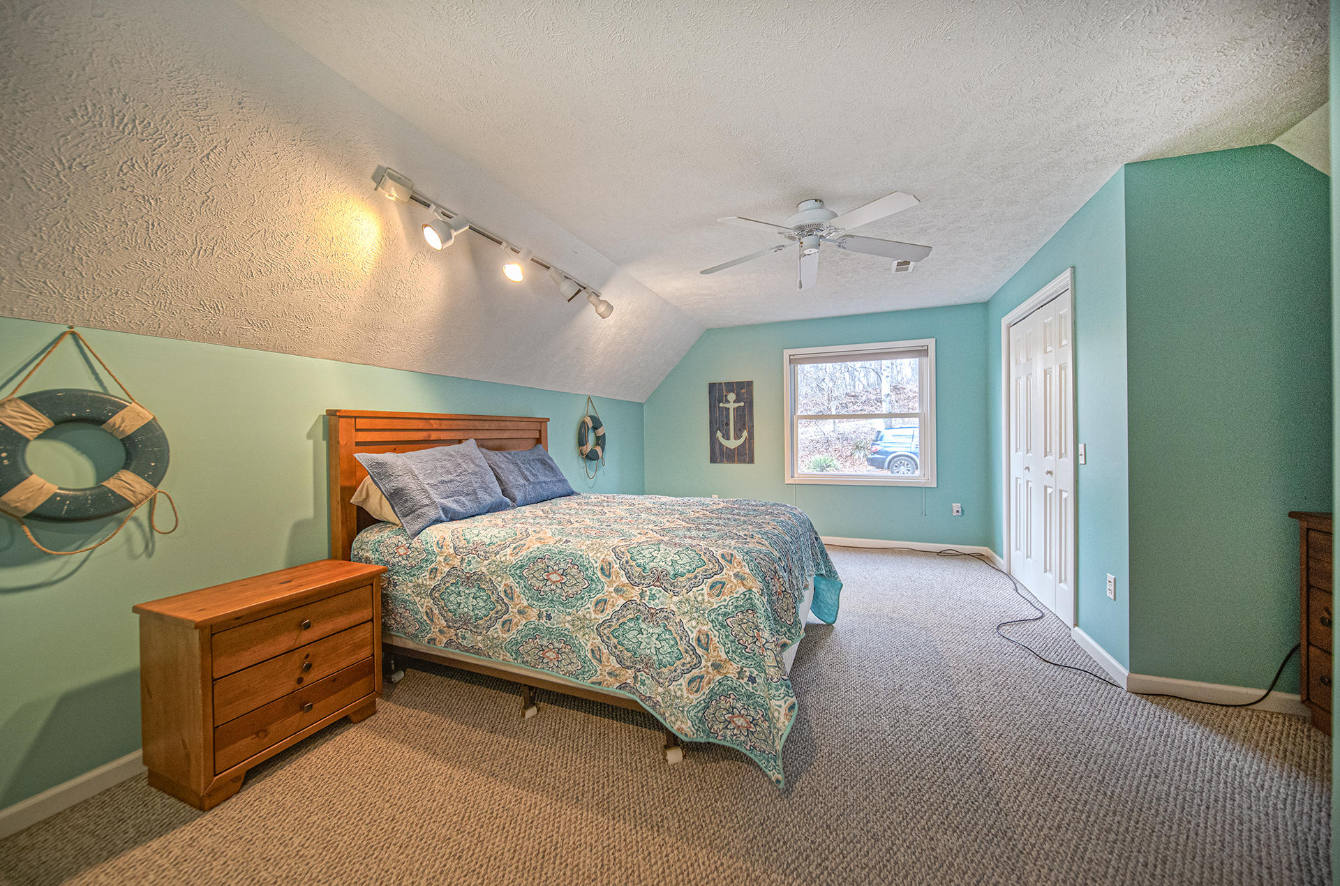 6136 Horseshoe Bend Road Goodview, VA 24095 - Photo 34 of 35 a bedroom with a bed and a chandelier