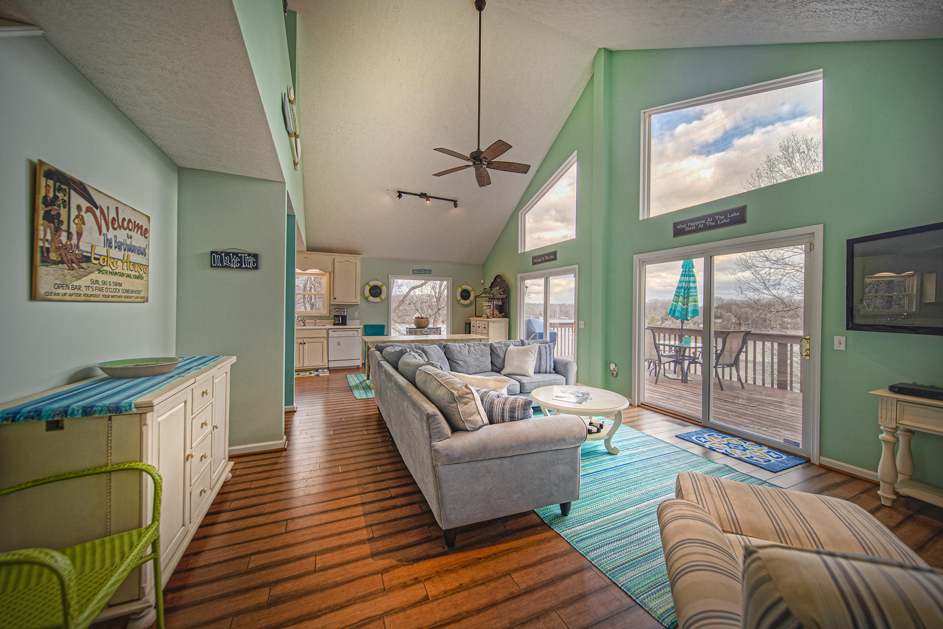 6136 Horseshoe Bend Road Goodview, VA 24095 - Photo 7 of 35 a living room with furniture floor to ceiling window and wooden floor