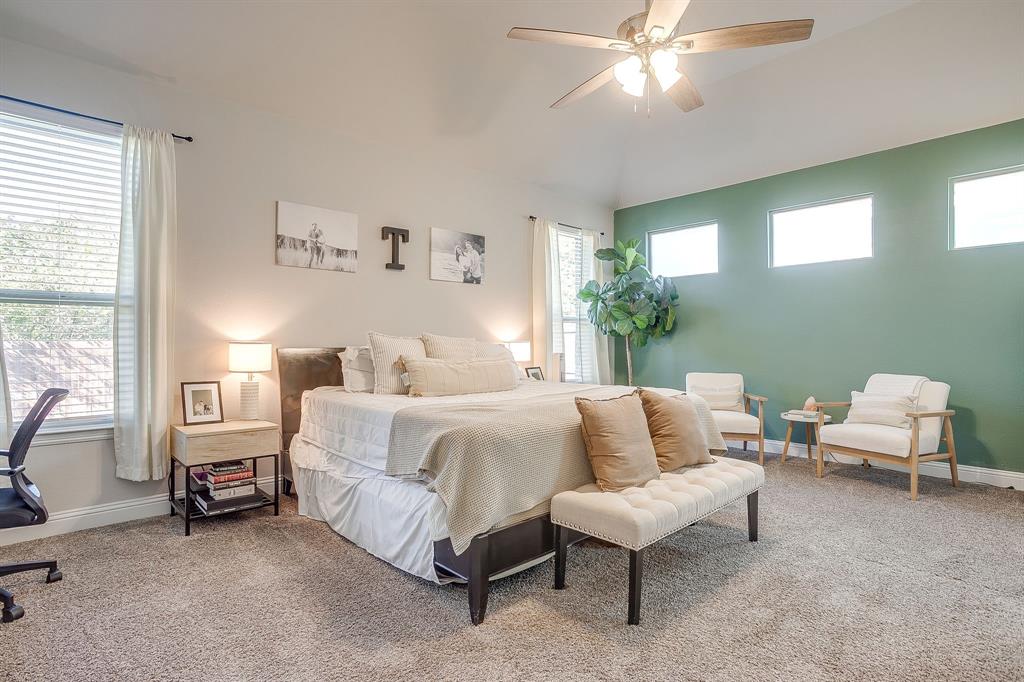 5821 Rendyn Court Midlothian, TX 76065 - Photo 17 of 30 a spacious bedroom with a bed a couch and a chandelier