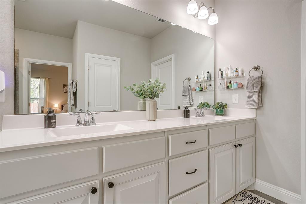 5821 Rendyn Court Midlothian, TX 76065 - Photo 19 of 30 a bathroom with a sink double vanity and a mirror