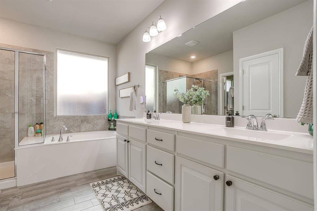 5821 Rendyn Court Midlothian, TX 76065 - Photo 21 of 30 a spacious bathroom with double vanity a mirror a vanity and a bathtub