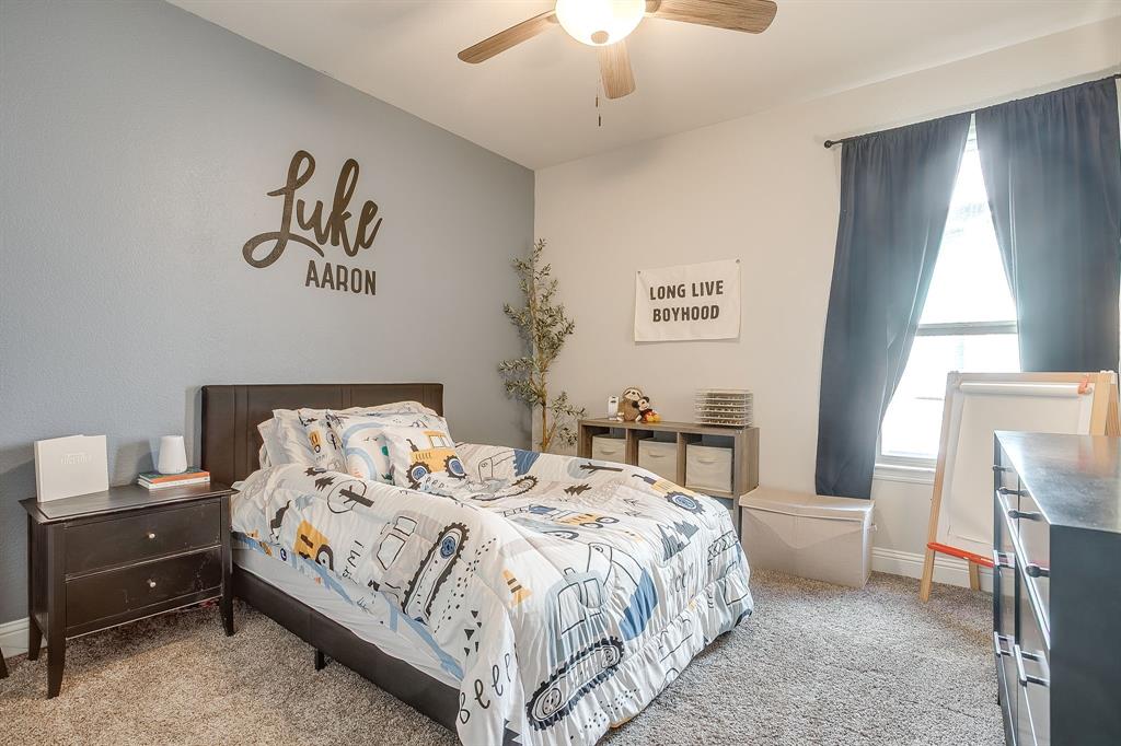 5821 Rendyn Court Midlothian, TX 76065 - Photo 22 of 30 a bedroom with a bed and a chandelier