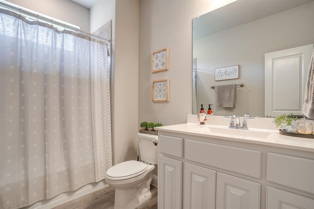 5821 Rendyn Court Midlothian, TX 76065 - Photo 23 of 30 a bathroom with a sink a toilet and a mirror