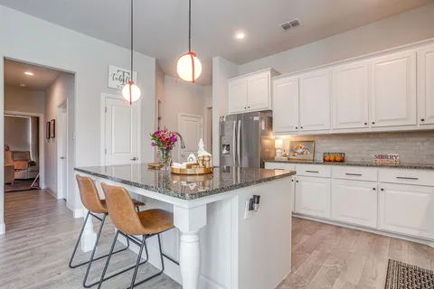 a kitchen with stainless steel appliances granite countertop a refrigerator sink and cabinets