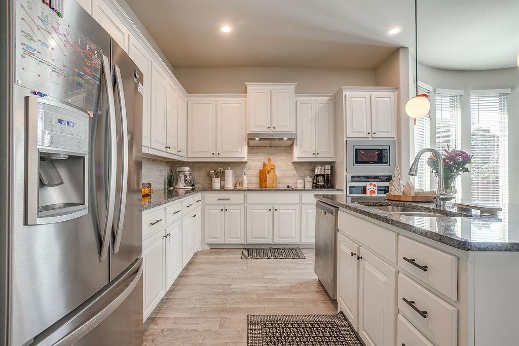 5821 Rendyn Court Midlothian, TX 76065 - Photo 8 of 30 a kitchen with stainless steel appliances granite countertop a refrigerator sink and cabinets