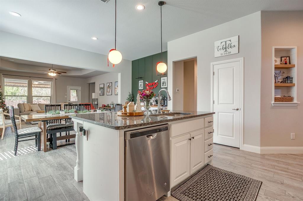 5821 Rendyn Court Midlothian, TX 76065 - Photo 9 of 30 a kitchen with stainless steel appliances granite countertop a kitchen island a stove and a sink