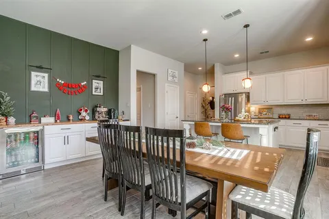 a living room with furniture a table and kitchen view