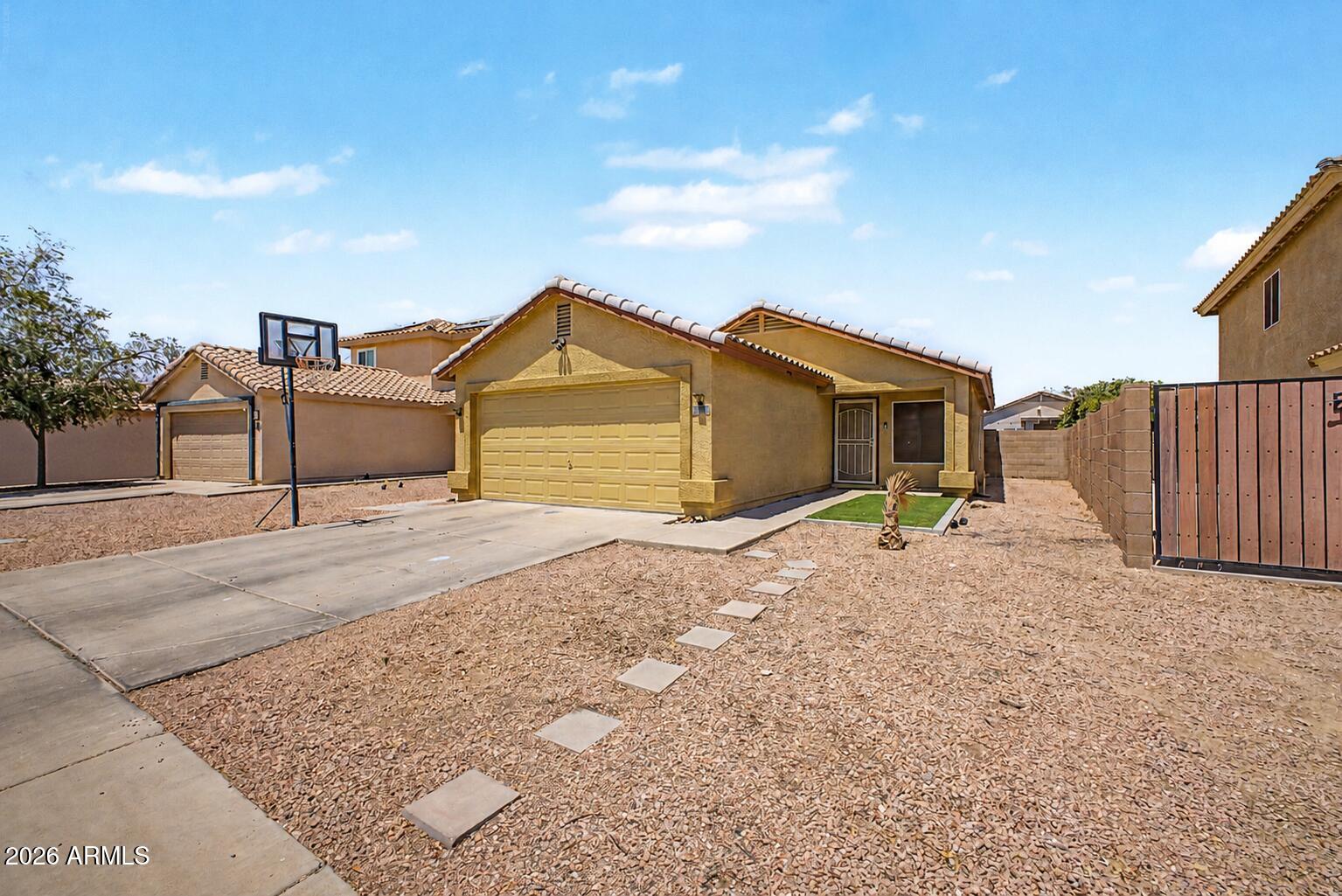 12008 West Larkspur Road El Mirage, AZ 85335 - Photo 25 of 25 a front view of a house with a yard and garage