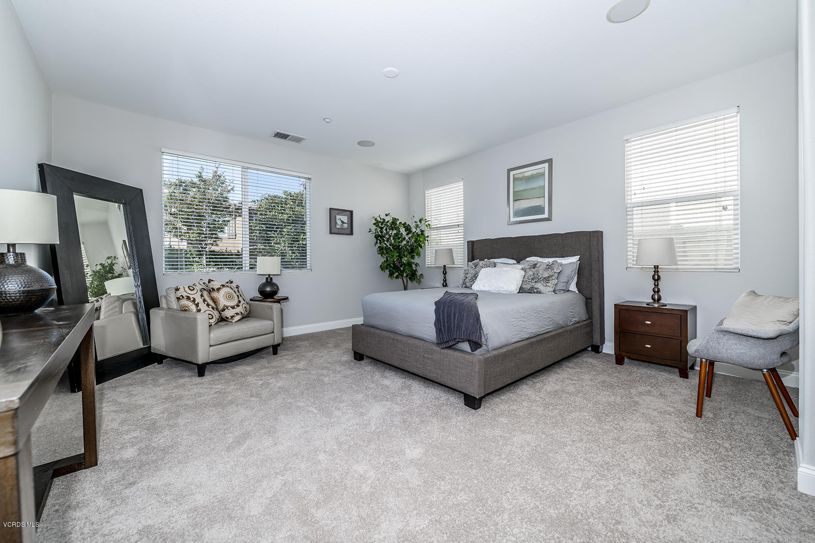 641 Riviera Court Oxnard, CA 93035 - Photo 11 of 18 a spacious bedroom with a bed and a couch
