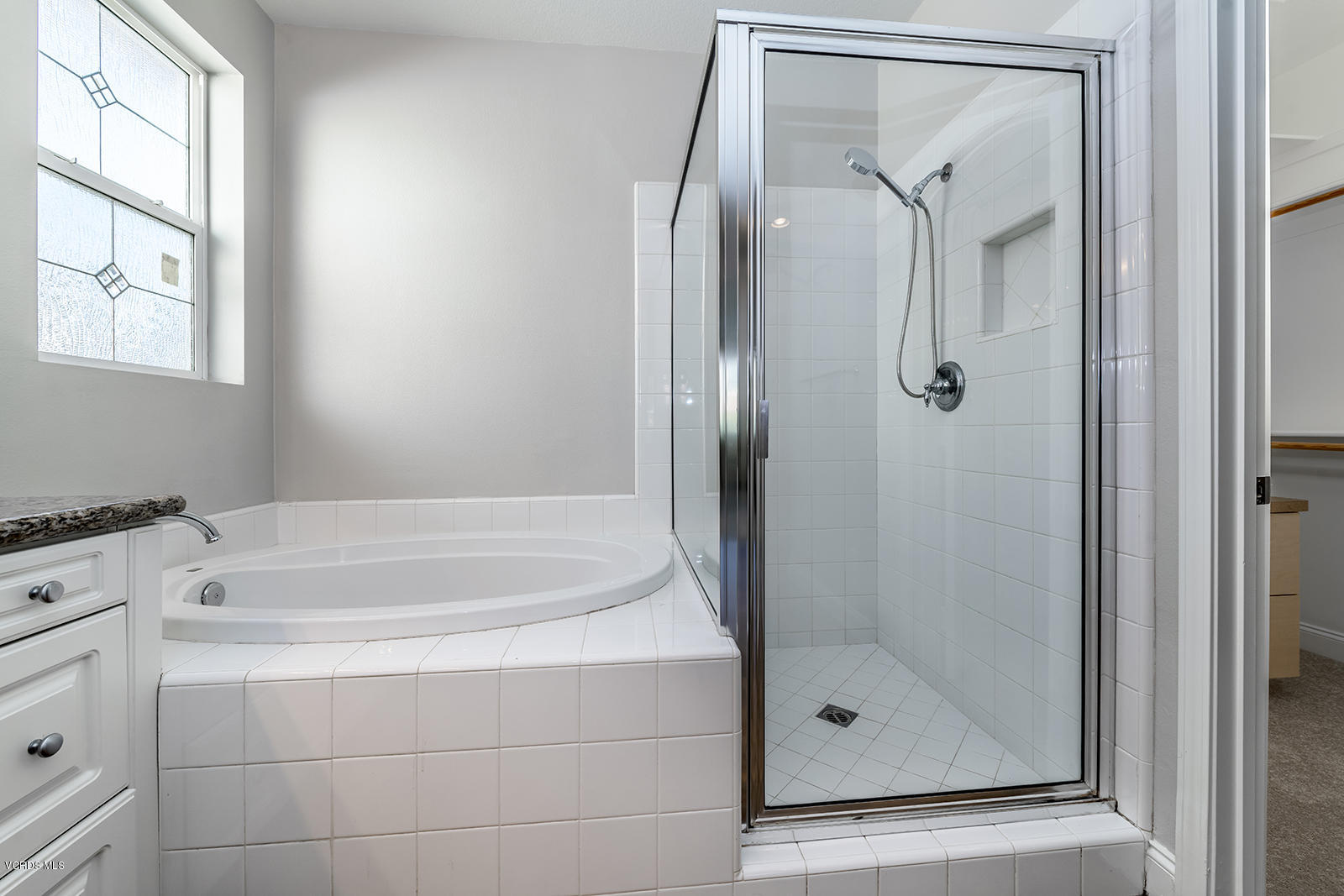 641 Riviera Court Oxnard, CA 93035 - Photo 13 of 18 a bathroom with a bathtub and a shower