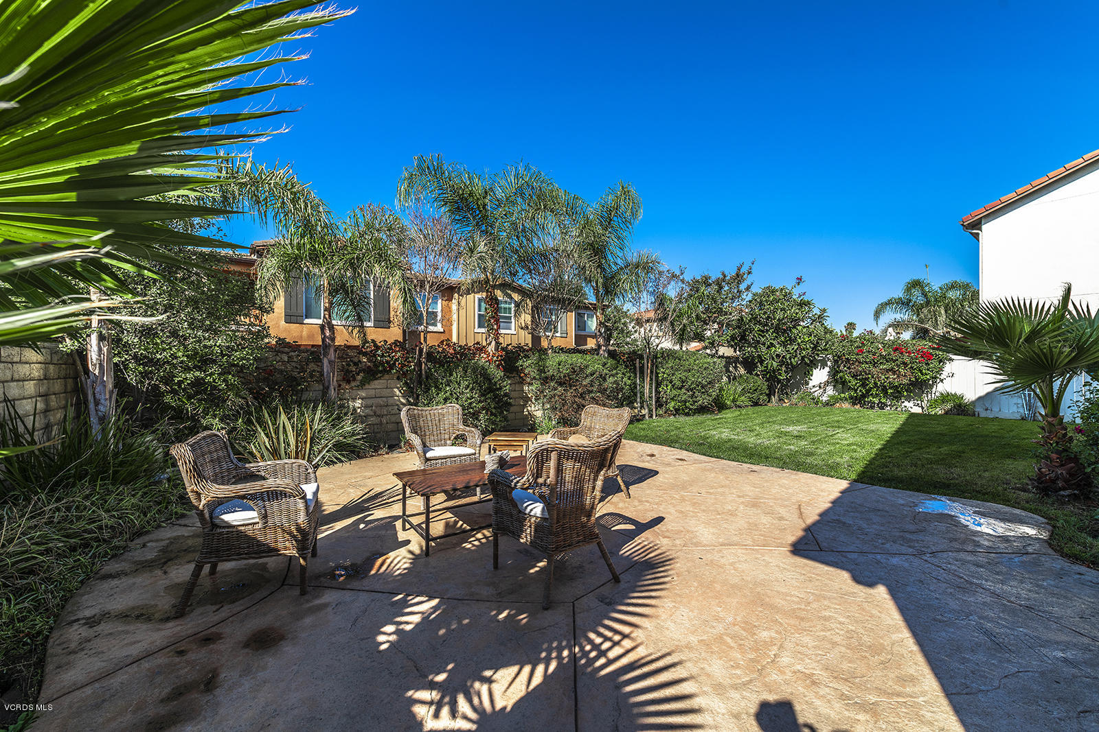 641 Riviera Court Oxnard, CA 93035 - Photo 17 of 18 a view of a patio with a table and chairs under an umbrella