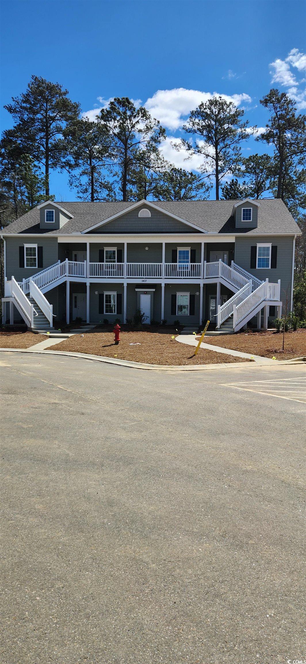 1407 Gooseneck Place, Unit 102 Murrells Inlet, SC 29576 - Photo 1 of 39 View of front facade featuring stairs
