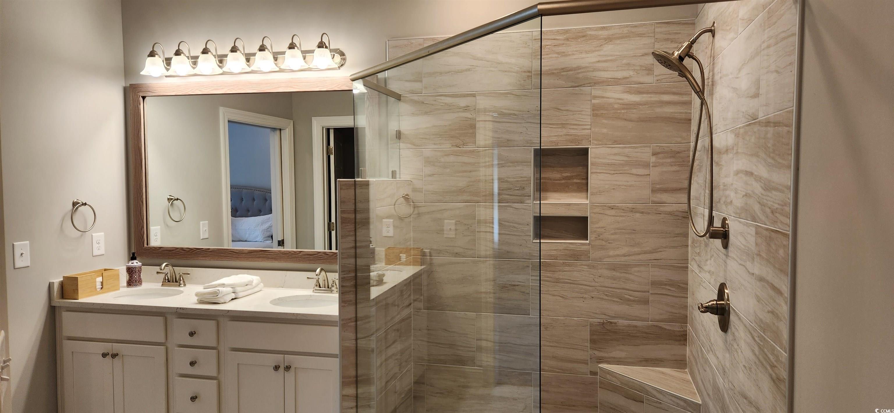 1407 Gooseneck Place, Unit 102 Murrells Inlet, SC 29576 - Photo 25 of 39 Bathroom featuring an enclosed shower and vanity
