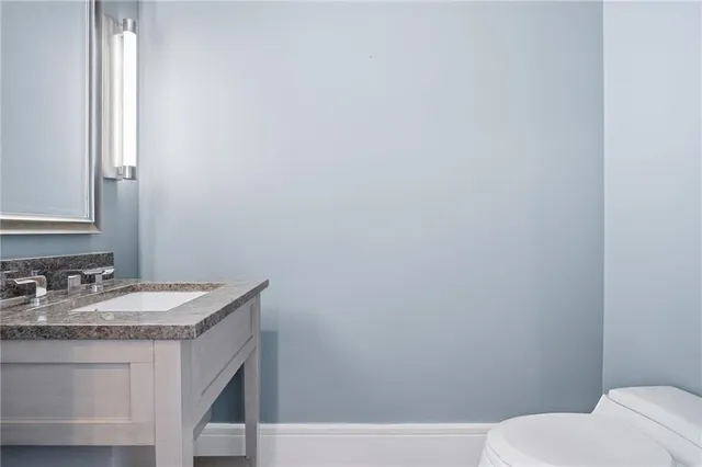 a view of a kitchen with a sink and an empty room