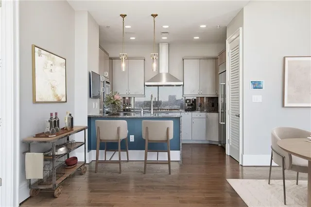 a kitchen with stainless steel appliances granite countertop a sink a stove and microwave