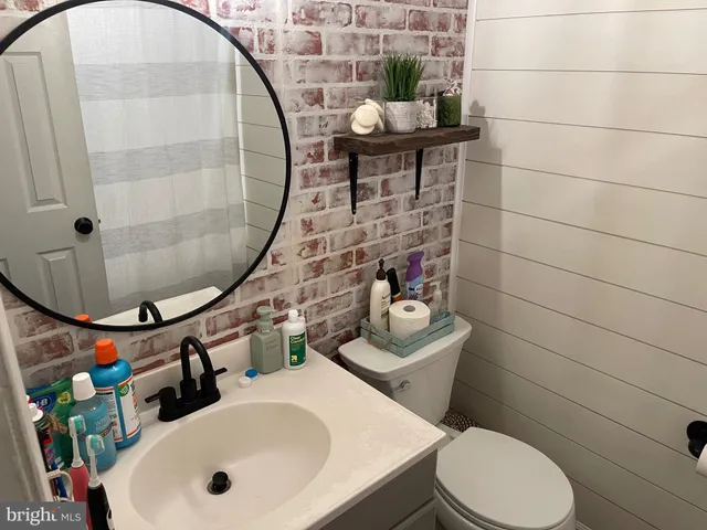 a bathroom with a toilet sink and mirror